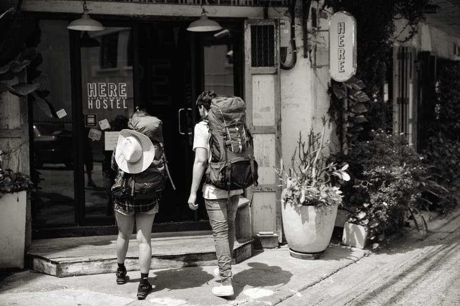 A travel backpack packed and standing upright