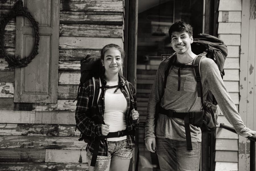 A travel backpack with an adjustable harness system