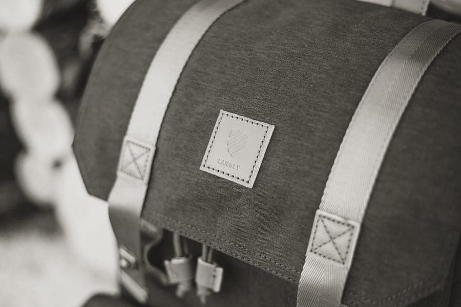 A clamshell travel backpack opened flat with packed compartments