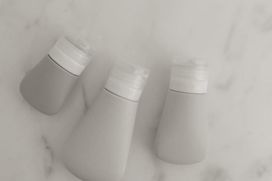 Small refillable travel bottles lined up on a bathroom counter
