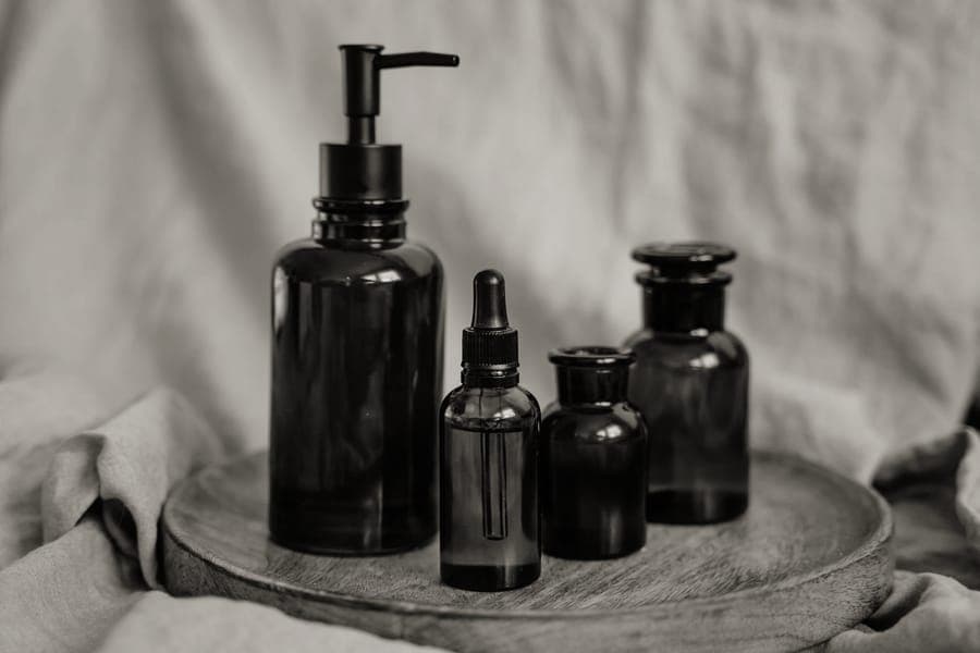 Small refillable travel bottles on a bathroom counter