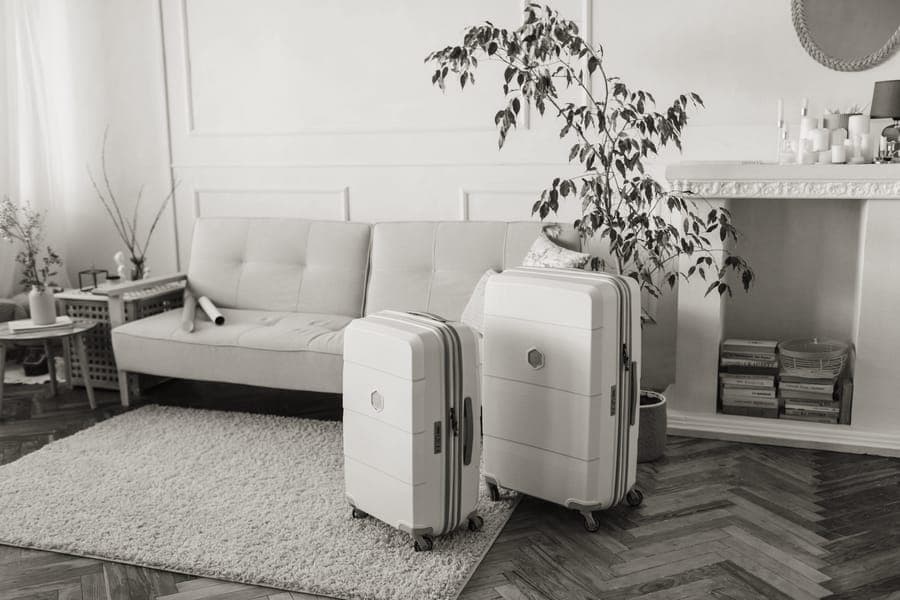 A hardside cabin suitcase on a paved street