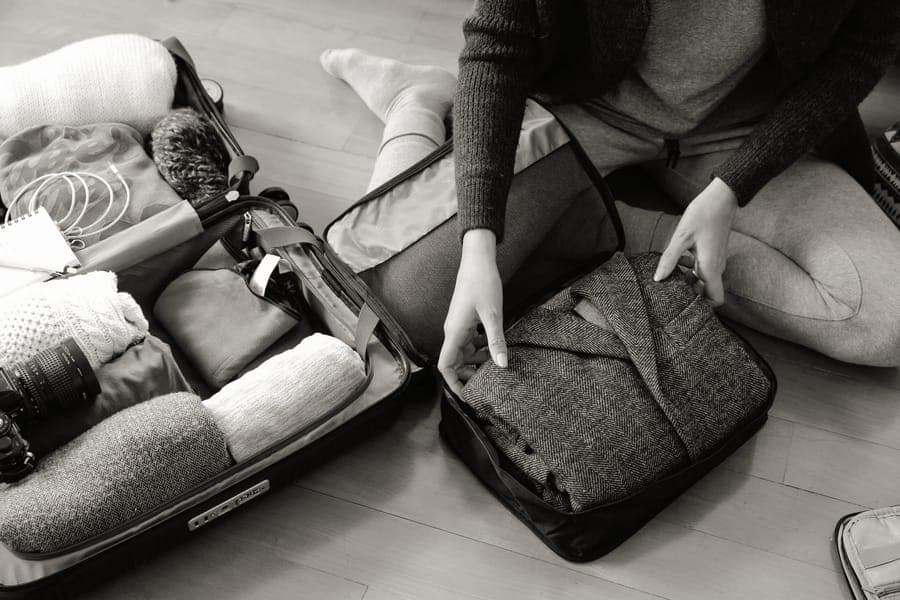 Mesh-topped packing cubes filled with folded clothes