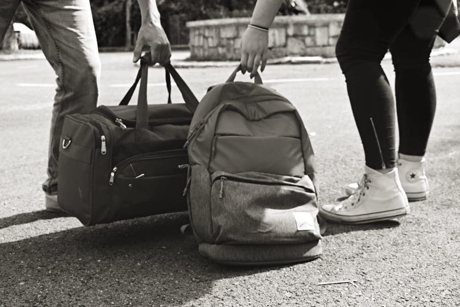 A soft-sided travel duffel bag packed and zipped
