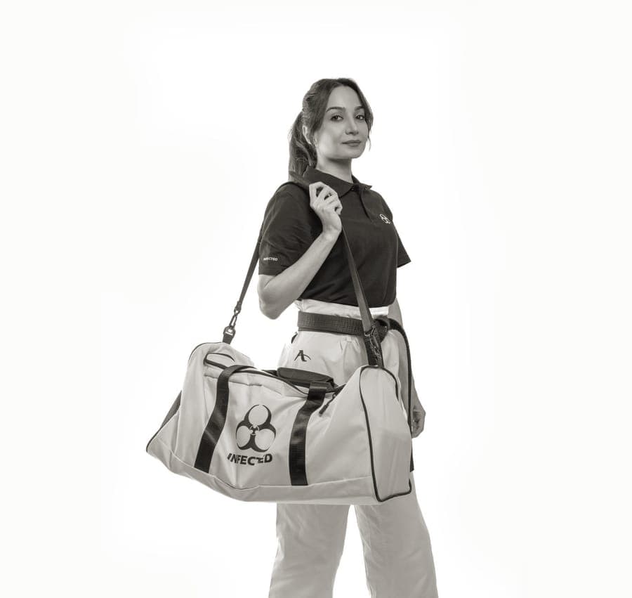 A coated fabric travel duffel bag with carry straps