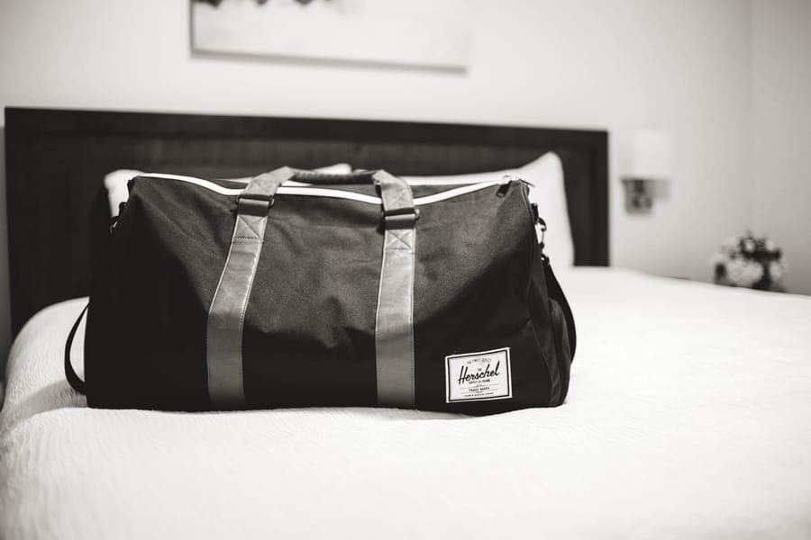 A foldable travel duffel bag with webbing handles