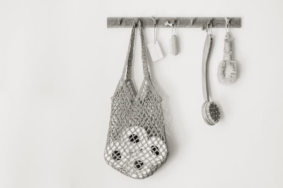 A hanging toiletry bag suspended from a bathroom hook