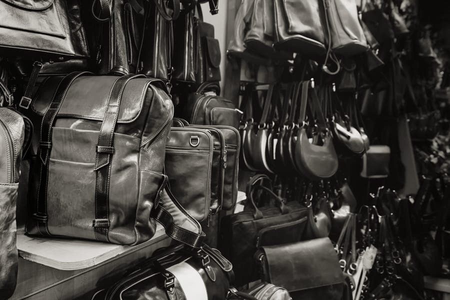 A slim daypack resting against a chair in a terminal