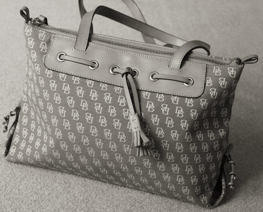 A structured travel tote bag with shoulder straps