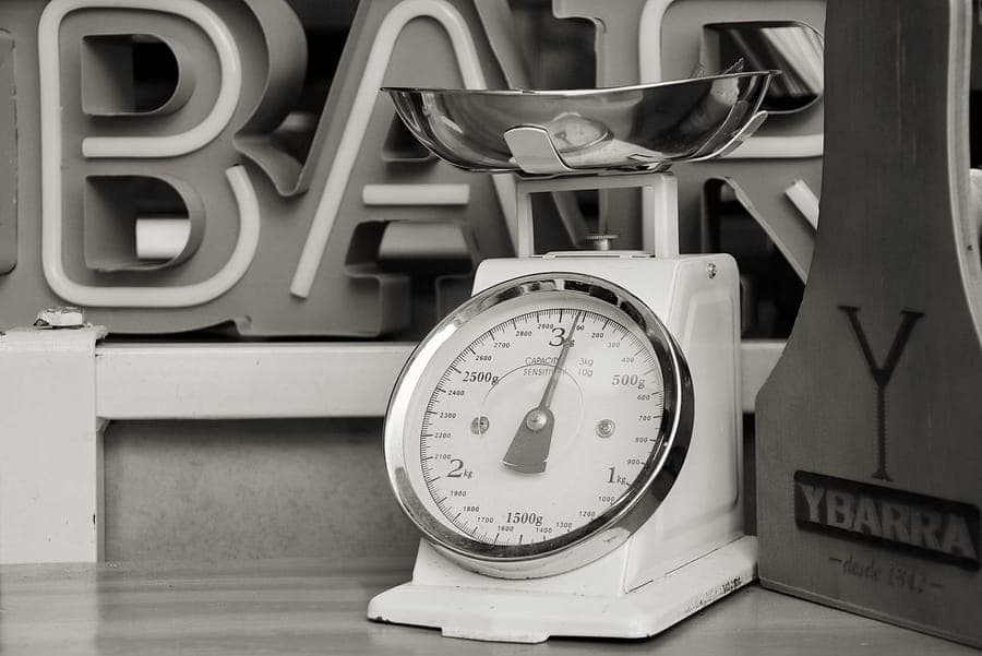 A compact digital luggage scale with a webbing strap