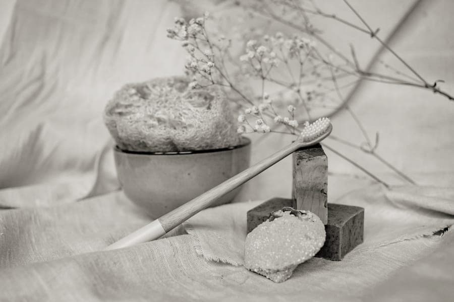 Solid shampoo and soap bars arranged on a stone surface