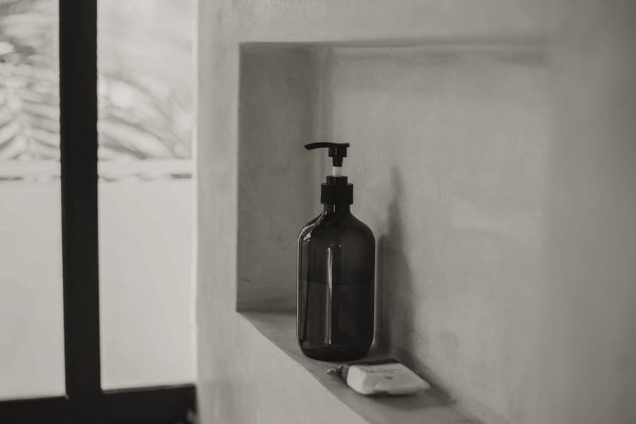 A clear zipped toiletry pouch holding small bottles