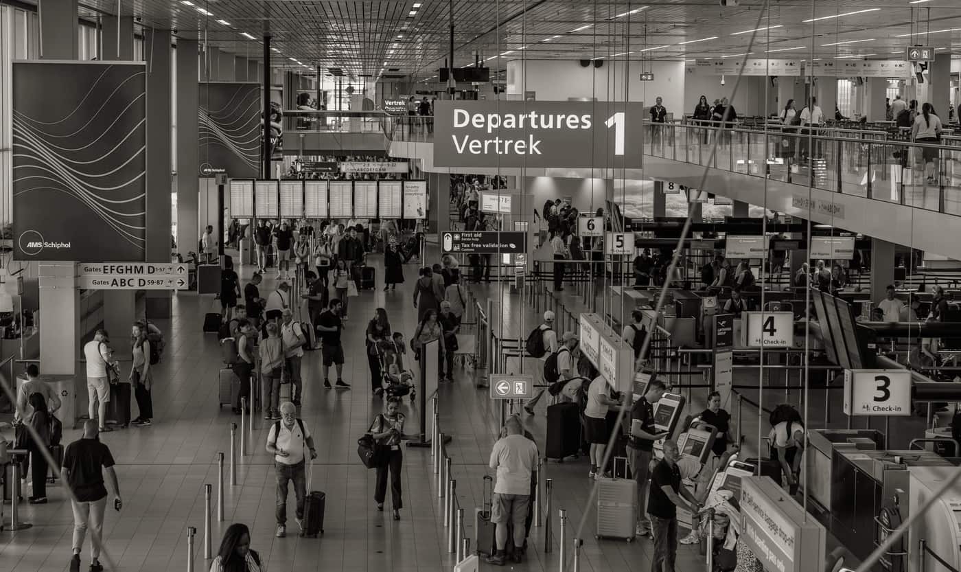 A softside suitcase being wheeled through an airport concourse