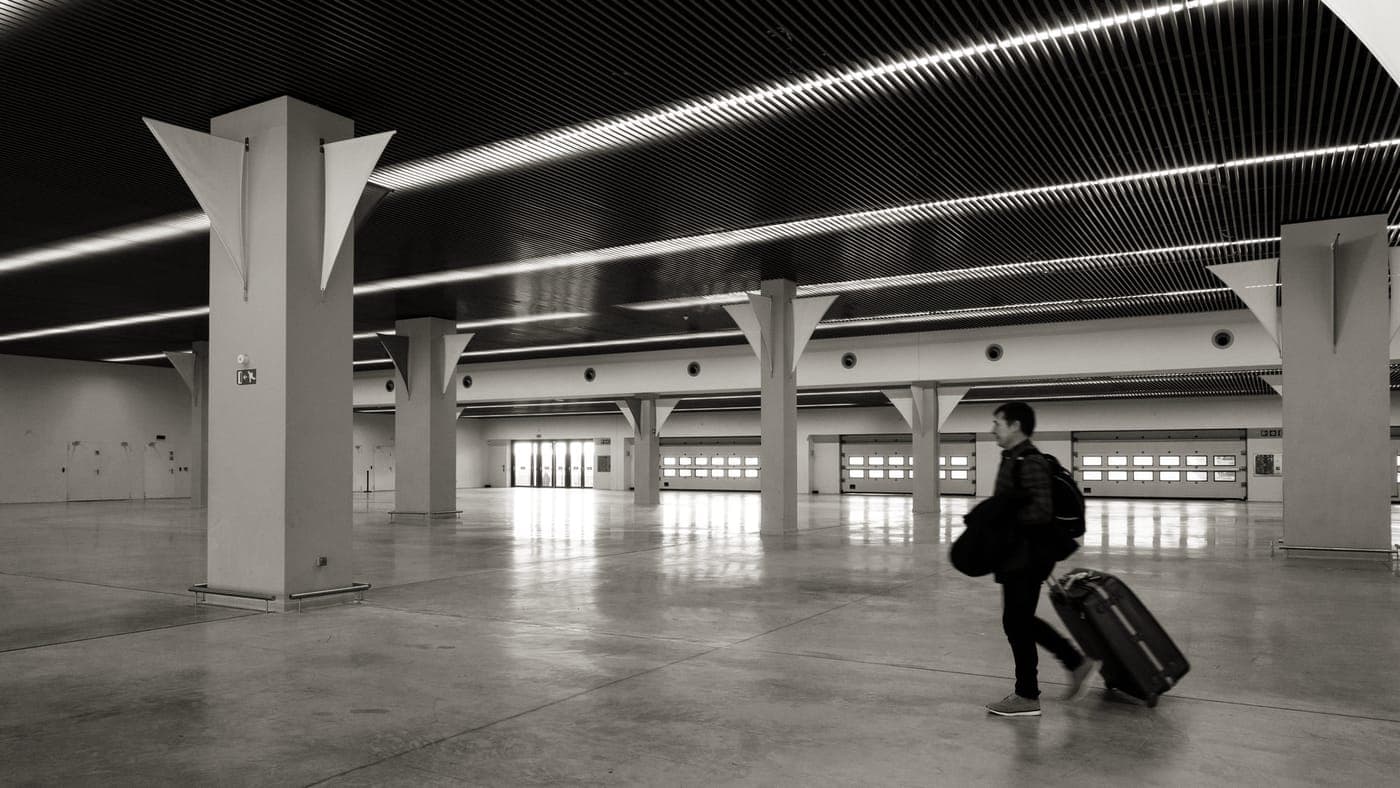 Travelers at an airport check-in area with luggage