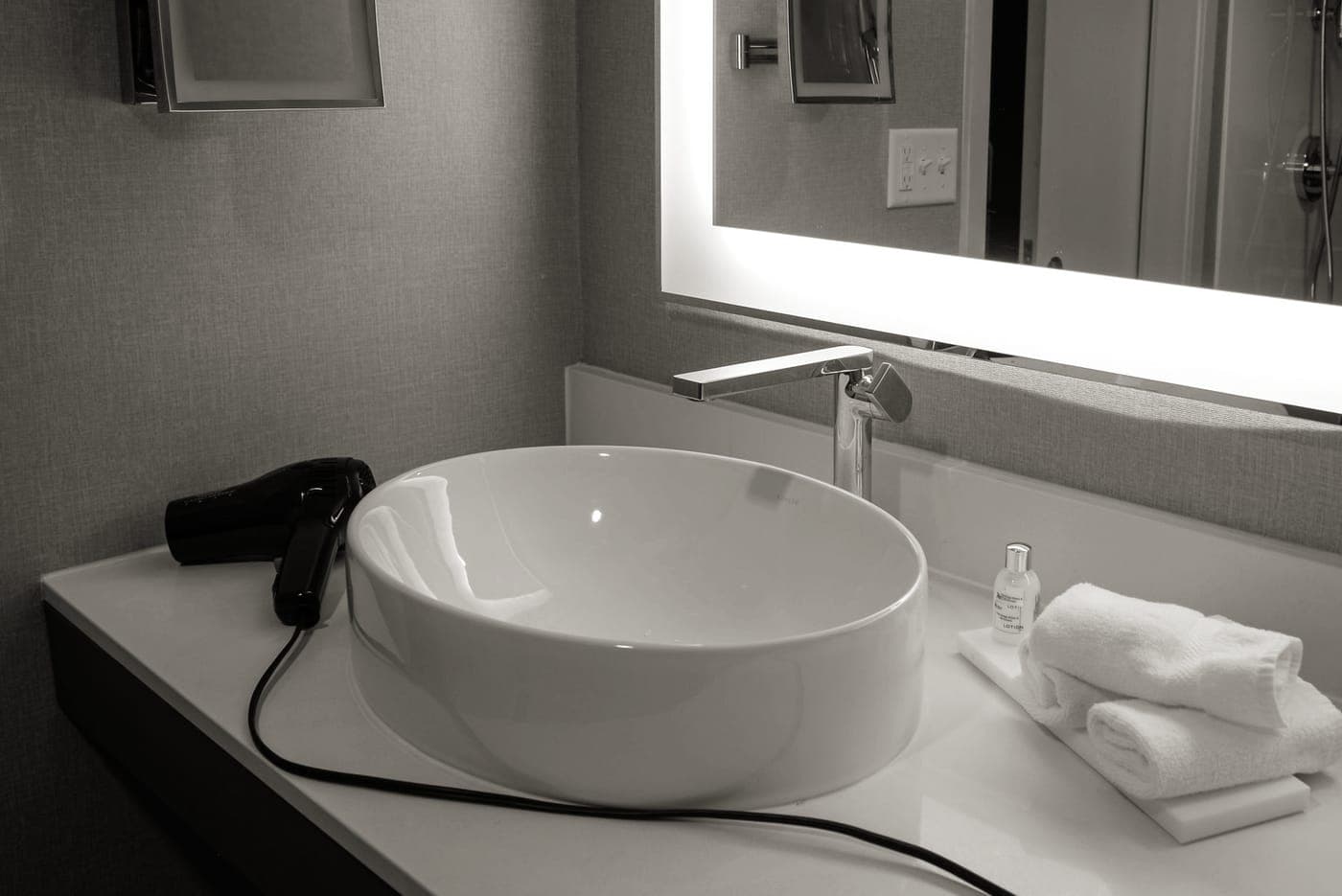 A toiletry bag open on a hotel bathroom counter