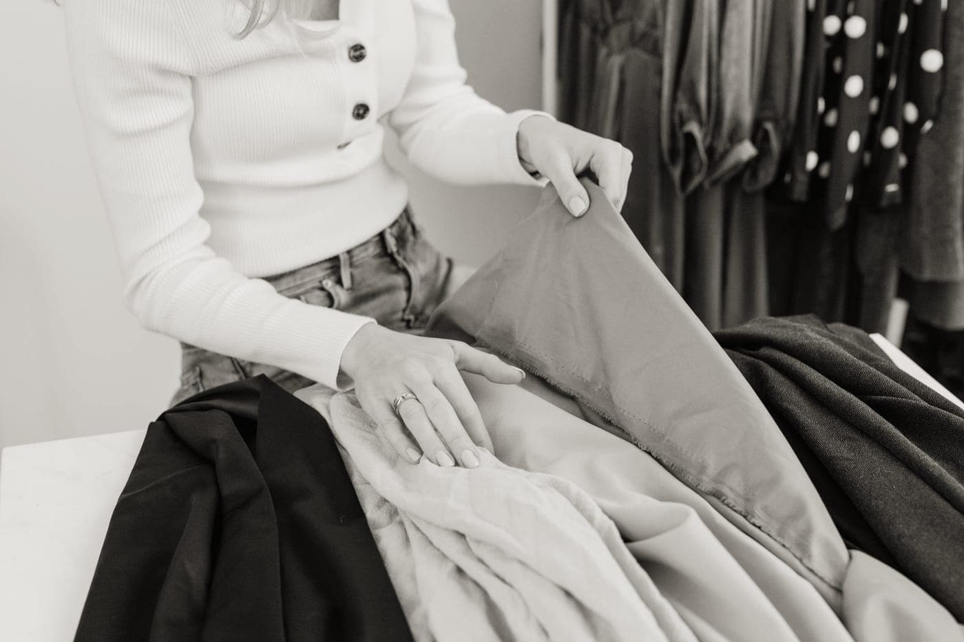 Bulky sweaters and layers being packed into a bag