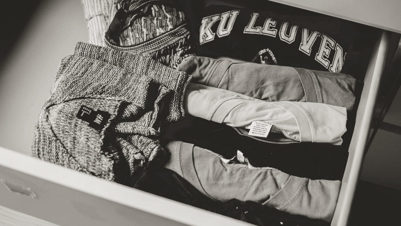 Clothes and travel organizer pouches laid out for packing