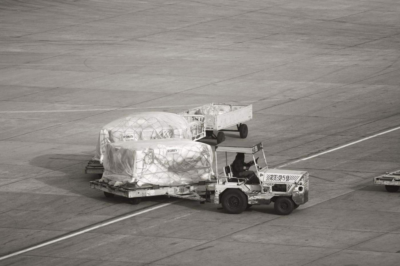 Trays of bags and belongings moving through an airport security scanner