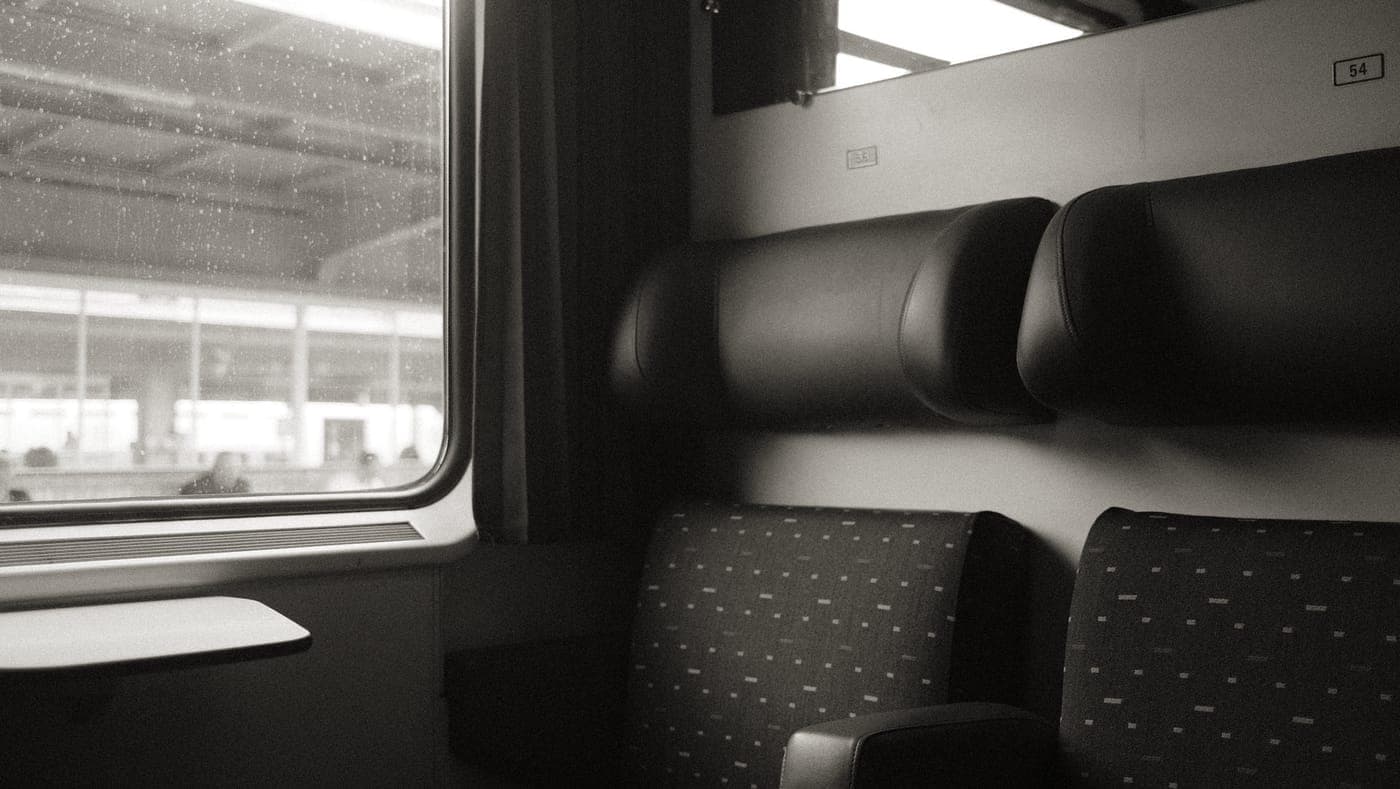 A traveler with a backpack on a train platform