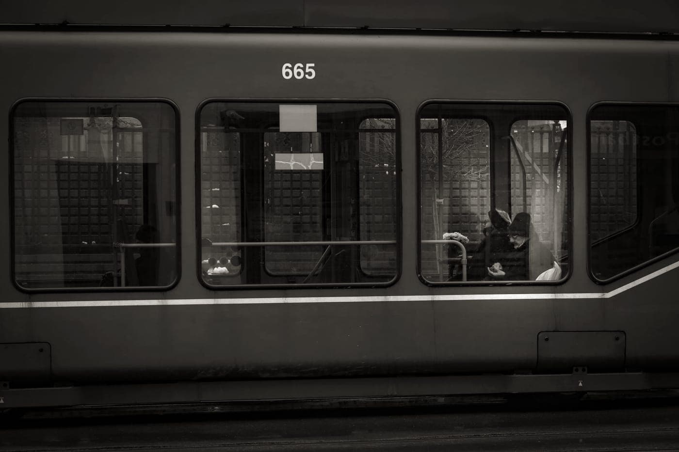A traveler carrying a backpack along a railway platform